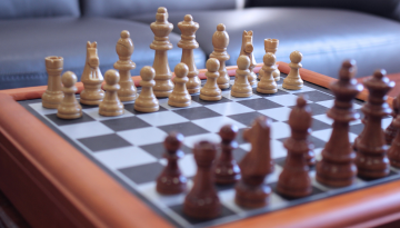 A chess board set up for the beginning of a game.